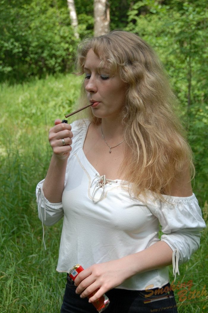 Busty blonde with hairy beaver is smoking in the forest-02
