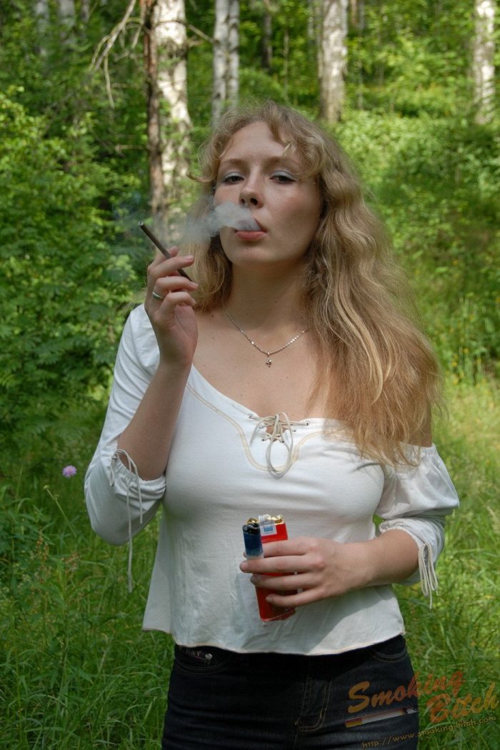 Busty blonde with hairy beaver is smoking in the forest-03