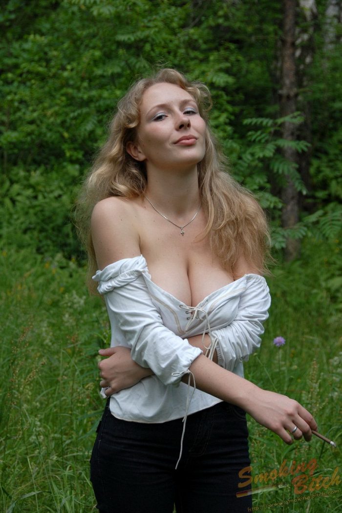 Busty blonde with hairy beaver is smoking in the forest-09