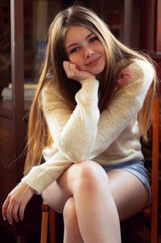 Cute girl Lana Lea removes a sweater and shorts to model in the nude